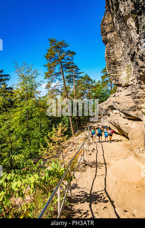 Hikers along the trail to Pravčická brána in Bohemian Switzerland, a picturesque region in the north-western Czech Republic. Stock Photo