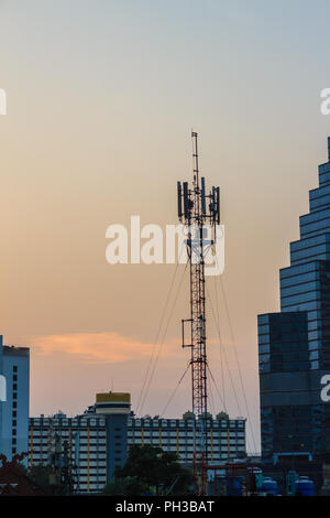 Cellular transmitter, antenna for telecommunications with colorful sky background. Silhouette amateur radio antenna tower in dramatic sky background. Stock Photo