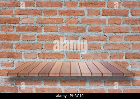 Brown wooden shelf on brick wall. For product display Stock Photo