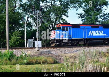 Bartlett, Illinois, USA. The locomotive leading a Metra commuter train past a signal in a rural stretch of Illinois on its journey from Chicago. Stock Photo
