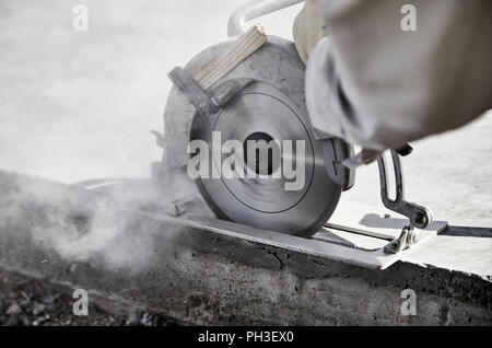 Close up of a circular saw cutting a concrete slab Stock Photo