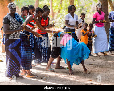 Kaguit vil., SENEGAL - APR 30, 2017: Unidentified Diola man makes somersault during a traditional dance Kumpo in a Sacred Forest near Kaguit village Stock Photo