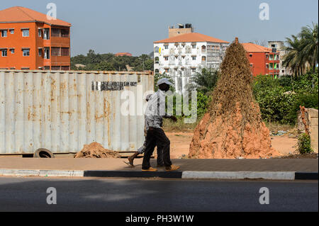 ROAD TO BISSAU, GUINEA B. - MAY 1, 2017: Unidentified local man walks beside the road in a village in Guinea Bissau. Still many people in the country  Stock Photo