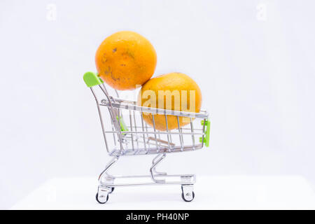 Orange fruit in cart on white background, Stock Photo