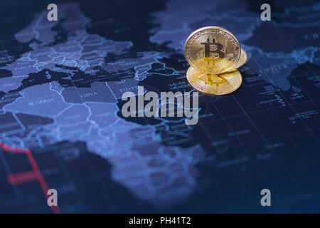 Cryptocurrency coin gold on blurred map world background, Stock Photo