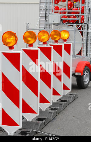 Road barrier with amber beacon flashing lights Stock Photo