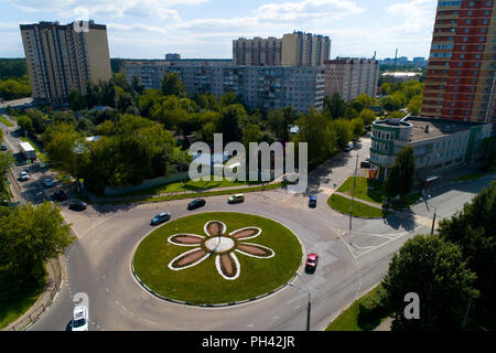 Top view of the road with a circular motion and a flower bed. Aerial photography. Stock Photo