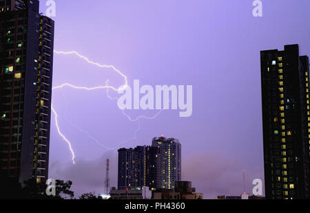 Real lightning striking on the night sky, monsoon season, Bangkok, Thailand Stock Photo