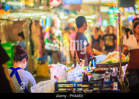 Bangkok, Thailand - March 2, 2017:  Street food vendor cooking and selling Pad Thai fried noodles at Khao San Road night market, Bangkok, Thailand. Stock Photo