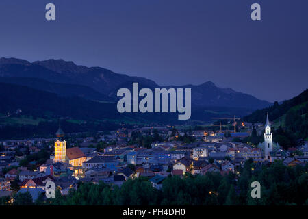 The town of Schladming, Austria, at dusk, set against the Dachstein Mountains Stock Photo