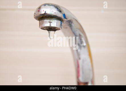 Drops of water falling down from the crane Stock Photo