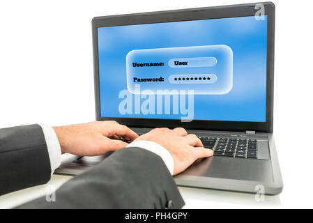 Businessman logging in on a laptop computer with the screen requesting his username and password as identification and security for access. Stock Photo