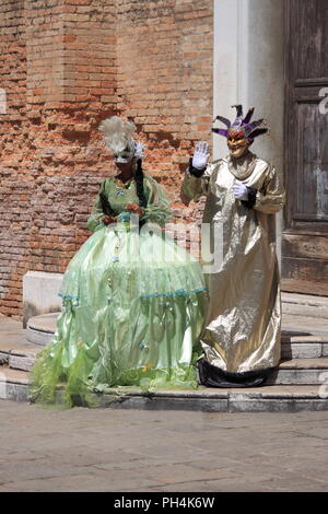 Venice, Italy - August 4, 2012: Two people in Venetian costume in the downtown of Venice, Italy Stock Photo