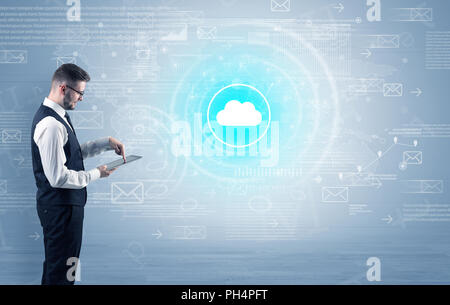 Standing businessman with data around and highlighted icon on the centre  Stock Photo