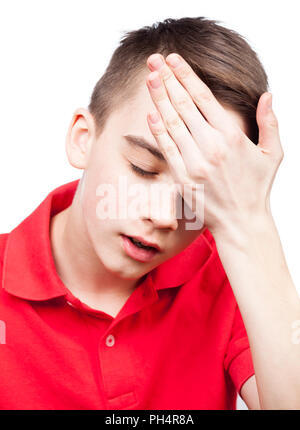 Portrait of teenager boy holding his hand on head suffering from migraine headache isolated on white background Stock Photo