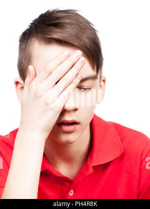 Portrait of teenager boy holding his hand on head suffering from migraine headache isolated on white background Stock Photo