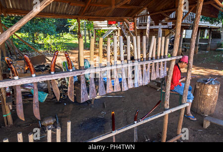 Display of knives and machetes in a roadside stall in Houayhe, a blacksmiths' village in the Bolaven Plateau, Champasak Province, Laos, southeast Asia Stock Photo