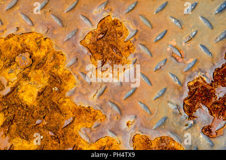 Old and rough diamond steel plate with large areas of rust Stock Photo