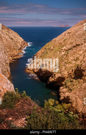 View of cove in Berlenga Grande island with Farilhões islands in the background. / Vista de enseada na Berlenga Grande com os Farilhões ao fundo. Stock Photo