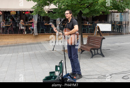 Guitar playing busker singer busking in Place Jacques-Cartier, Old Town, Montreal, QC, Canada Stock Photo