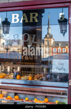 The Plaza Mayor Reflected in the window of a cerveceria and Tapas bar, Plaza Mayor, Madrid, Spain Stock Photo