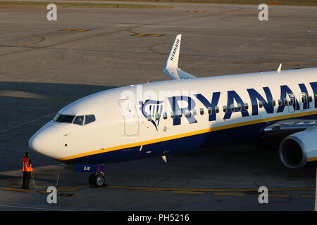 Front of a Ryanair aircraft on the tarmac at Pula airport in Croatia as it prepares for take off with ground crew by the front wheels. Stock Photo