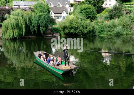 Man using a hand pulled ferry boat to cross the River Wye Symonds Yat England Stock Photo