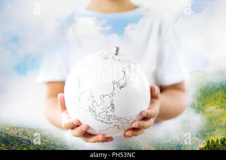 Life on earth - environment and ecology concept double exposure earth globe in child hands and nature landscape Stock Photo