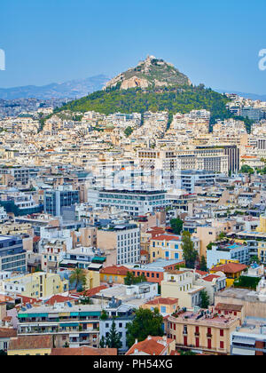 Athens, Greece - July 1, 2018. View of the city of Athens with the Lykavittos hill in background. View from the viewpoint of Athenian Acropolis. Attic Stock Photo