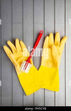 Yellow rubber gloves and washing up brush Stock Photo