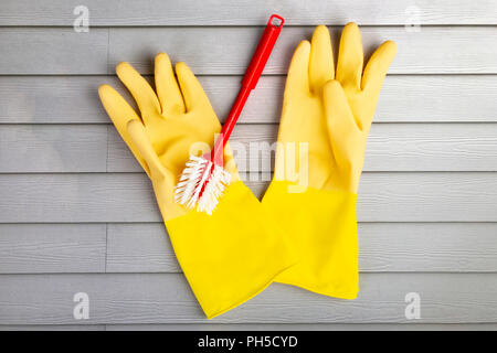 Yellow rubber gloves and washing up brush Stock Photo