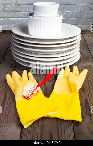 Yellow rubber gloves and washing up brush Stock Photo