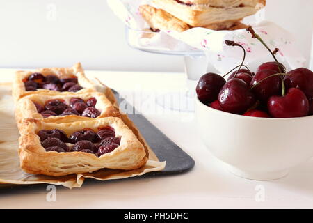 Freshly baked puff pastry squares with cherries Stock Photo