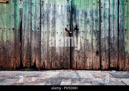 Old weathered wooden closed door, grungy background. Stock Photo