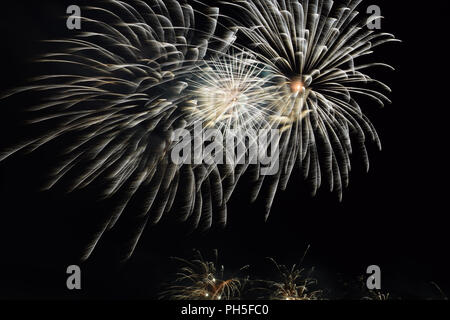 silver firework effects in the clear night sky, firework display for celebration by night Stock Photo