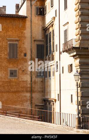 esplanade at the back of the Piti palace, from the Boboli gardens, in Florence, with its old walls in a worn light brown color and the blinds in green Stock Photo