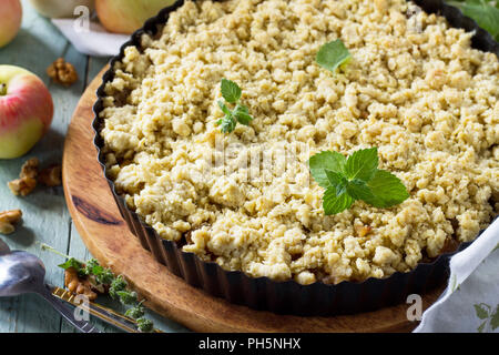 An English cake in a baking dish on a wooden board and a white wooden  table. Selective focus Stock Photo - Alamy