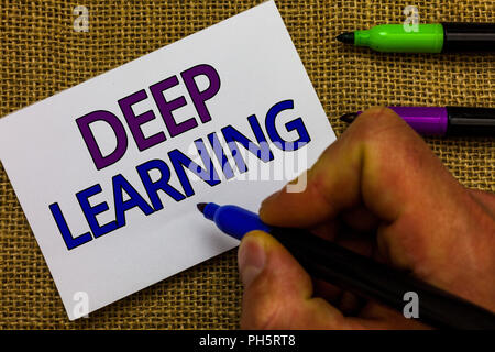 Text sign showing Deep Learning. Conceptual photo Hierarchical Abstractions Artificial Intelligence Algorithm Man hand holding marker white paper comm Stock Photo