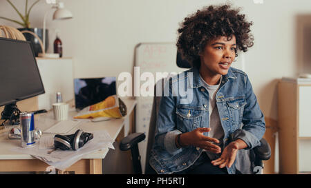 Female startup owner sharing few business ideas with team. businesswoman explaining new software development project to her team. Stock Photo