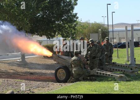 Guest Blackhorse Troopers render honors by firing a volley from the M116 75mm Howitzer during the 11th Armored Cavalry Regiment Change of Command ceremony on Fort Irwin’s Fritz Field, June 28, 2018. This time-honored ceremony commemorates the dedication and selfless service demonstrated by Col. Joseph Clark and ushering in a new chapter of leadership for the Blackhorse Regiment. Stock Photo