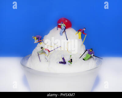 food, macro, skiers, ski skiing on a mountain of ice cream cherry on top falling concept fun funny Stock Photo