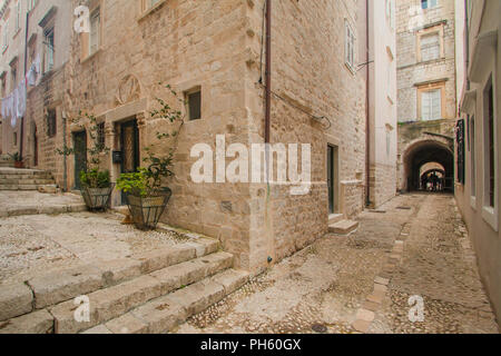 Plants and palms in old wooden barrels in narrow street in the Old Town in Dubrovnik, Croatia, mediterranean ambient Stock Photo