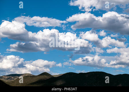 Puffy white cumulus clouds against a clear blue central Colorado sky; USA Stock Photo