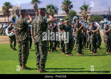 Lt. Col. Christopher D. Siler, off-going commanding officer, Marine Wing Support Squadron 374-, and Lt. Col. Eric M. Beckmann, on-coming commanding officer, MWSS 374-, conduct a pass and review during a change of command ceremony at Lance Cpl. Torrey L. Gray Field aboard the Marine Corps Air Ground Combat Center, Twentynine Palms, Calif., June 25, 2018. Changes of command ceremonies are a Marine Corps tradition that signifies the transition of unit leadership from one officer to another. Stock Photo