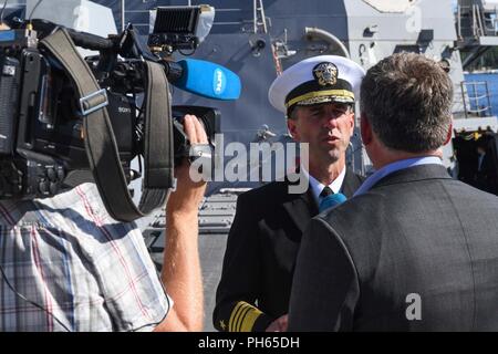 Norway (June 25, 2018) Chief of Naval Operations Adm. John Richardson answers questions from the Norwegian press aboard the Arleigh Burke-class guided-missile destroyer USS Bainbridge (DDG 96), during a reception in Oslo, Norway, June 25, 2018. U.S. Naval Forces Europe-Africa/U.S. 6th Fleet, headquartered in Naples, Italy, conducts the full spectrum of joint and naval operations, often in concert will allied and interagency partners, in order to advance U.S. national interests and security and stability in Europe and Africa. Stock Photo