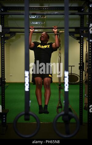 VICENZA, Italy -- U.S. Army Paratrooper Staff Sgt. Derek Farrington, human resources Non-commissioned officer (NCO) assigned to Headquarters and Headquarters Company, 173rd Brigade Support Battalion, 173rd Airborne Brigade, performs pullups during Soldier Performance Education for Advanced Readiness and Resilience (SPEAR) training. SPEAR aims to improve readiness, deployability, and Soldier athlete performance to ensure the U.S. Army's human capital investment is well managed for extended and high performance careers. Stock Photo