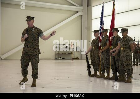 Col. Russell C. Burton, left, commanding officer, Marine Corps Air Station New River, gives his remarks during a change of command ceremony for Headquarters and Headquarters Squadron (H&HS), MCAS New River, at the Center for Naval Aviation Technical Training on New River, N.C., June 15, 2018. The change of command formally transferred authorities and responsibilities of H&HS from Lt. Col. Quentin Vaughn to Lt. Col. Matthew T. Daigneault. Stock Photo