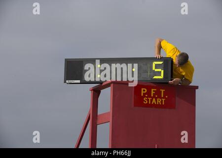 Gunnery Sgt. James L. Collier, chief drill instructor, Fox Company, 2nd Recruit Training Battalion, resets a timer during a physical fitness test at Marine Corps Recruit Depot San Diego, June 25. During the final portion of the test, recruits must run three miles as quickly as possible to complete the test. Annually, more than 17,000 males recruited from the Western Recruiting Region are trained at MCRD San Diego. Fox Company is scheduled to graduate Aug. 10. Stock Photo