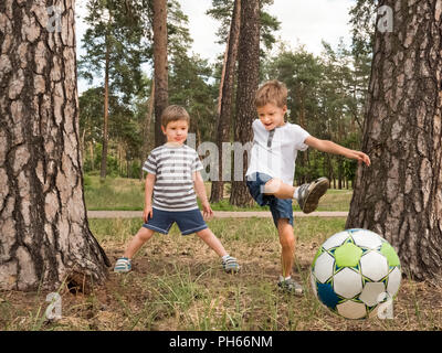 Children playing soccer outdoor. Leisure activities for children Stock Photo