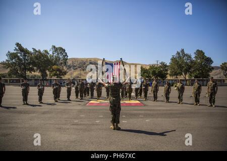 The 1st Marine Division Band plays prior to the 2nd Battalion, 11th Marine Regiment, 1st Marine Division, change of command ceremony at Marine Corps Base Camp Pendleton, Calif., June 26, 2018. The change of command ceremony represents the official passing of authority from the offgoing commander, Lt. Col Patrick F. Eldridge, to the incoming commander, Lt. Col. Caleb Hyatt. Stock Photo